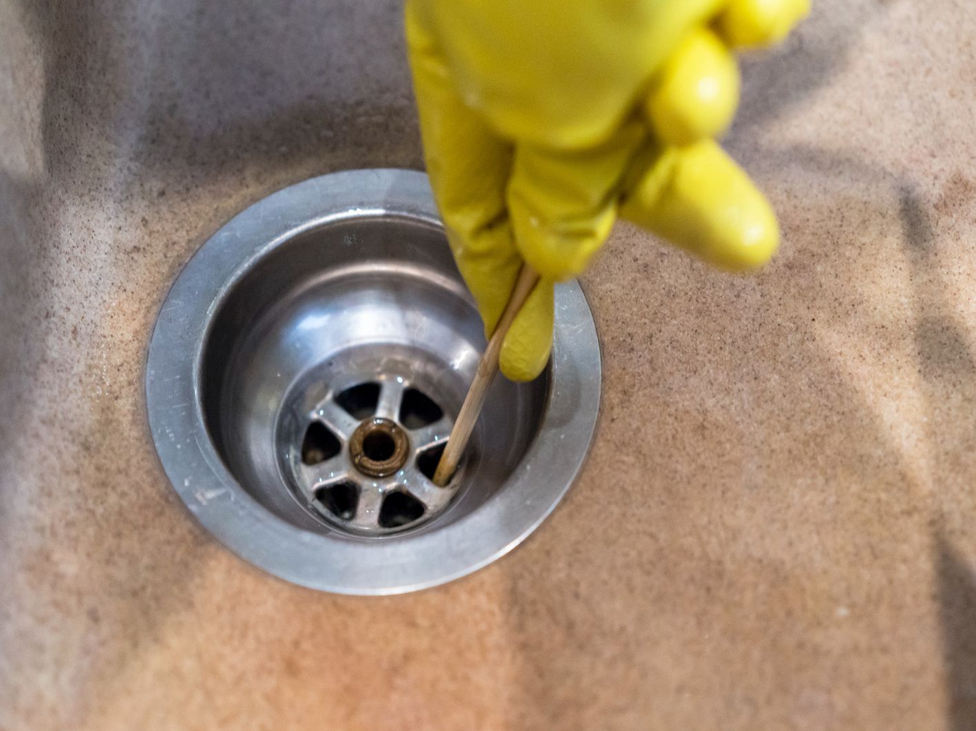 Homeowner in Regina unclogs the kitchen sink.